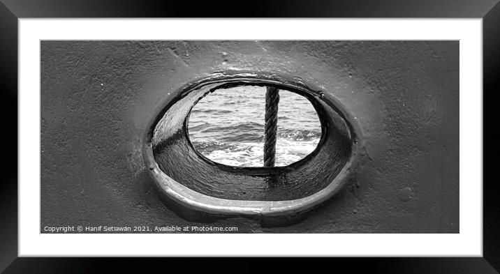 Bull´s eye in a blue iron wall from a ship. 1bw Framed Mounted Print by Hanif Setiawan