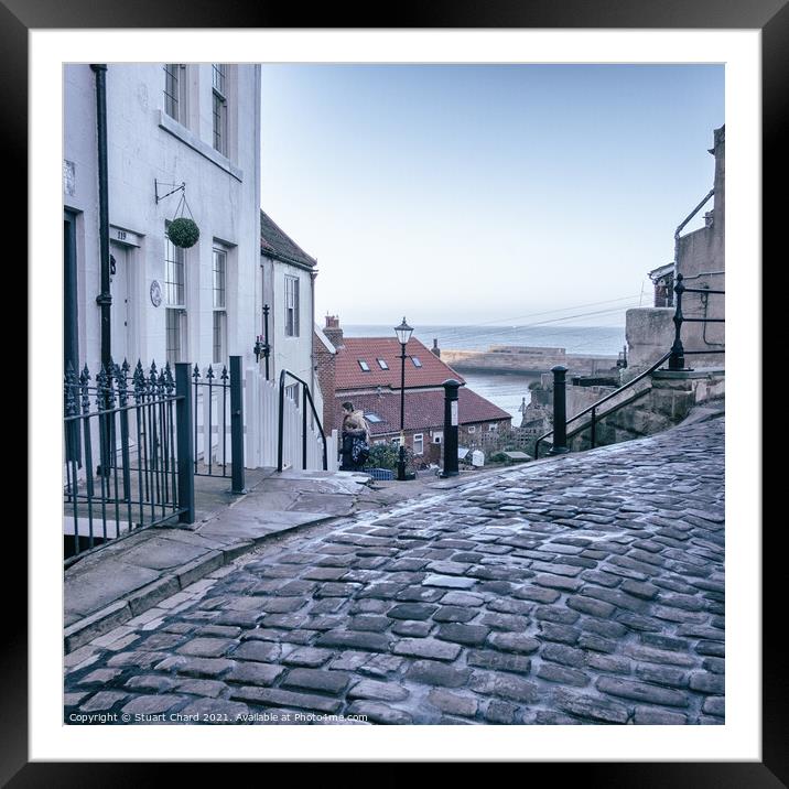 Whitby town cobbled streets and sea view Framed Mounted Print by Travel and Pixels 