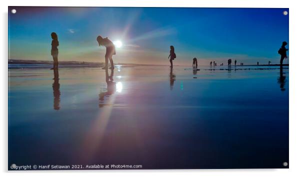 Silhouetted people in a row on a wet sand beach. Acrylic by Hanif Setiawan