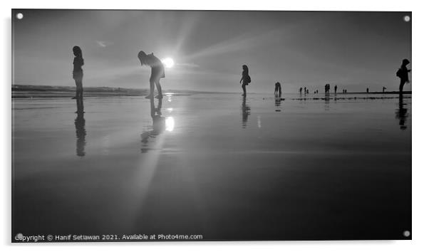 Silhouetted people in a row on a wet sand beach. Acrylic by Hanif Setiawan