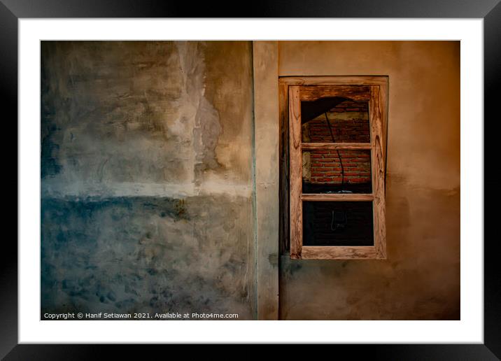 A wooden window on yellow brown wall. Framed Mounted Print by Hanif Setiawan