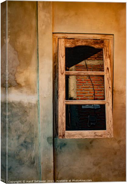 A wooden window on yellow brown wall. Canvas Print by Hanif Setiawan