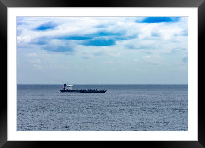 cargo ship on the high seas sailing towards port Framed Mounted Print by David Galindo