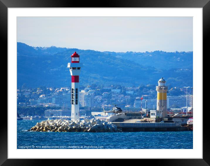 Helicopter landing next to Lighthouse Framed Mounted Print by Ann Biddlecombe