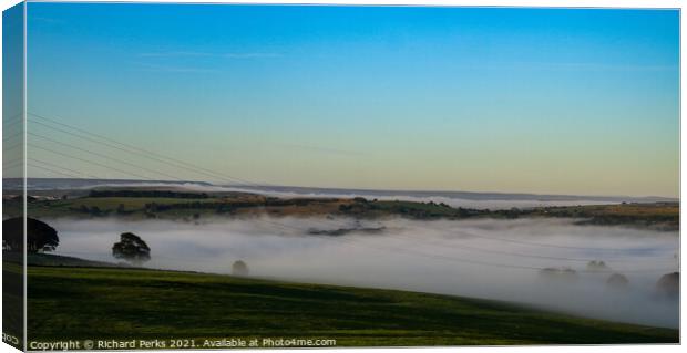 Mist in the valleys Canvas Print by Richard Perks