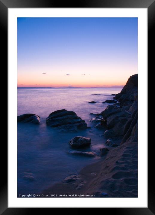 Long exposure of sea around rocks on beach Framed Mounted Print by Nic Croad