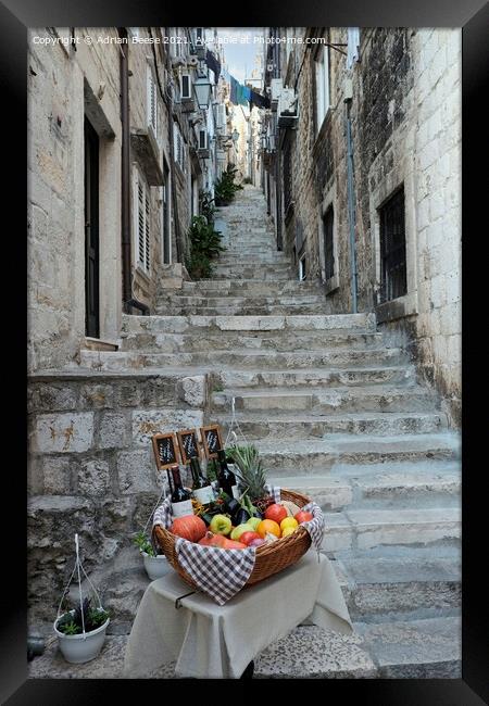 Basket of wine and fruit in Dubrovnik Framed Print by Adrian Beese