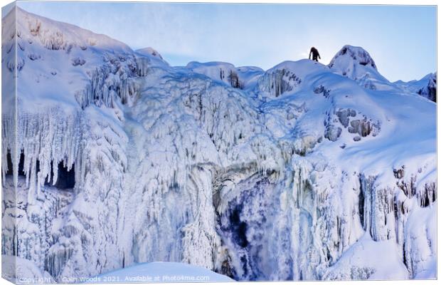 The figure of a person on the top of the frozen Chutes de Chaudière at Charny near Quebec City, Canada Canvas Print by Colin Woods
