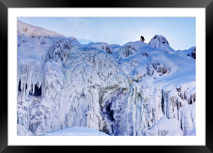 The figure of a person on the top of the frozen Chutes de Chaudière at Charny near Quebec City, Canada Framed Mounted Print by Colin Woods