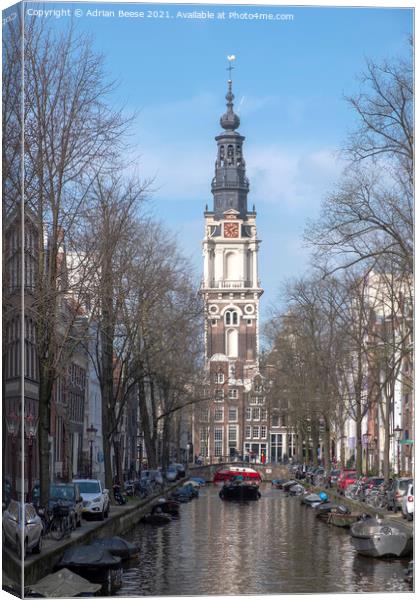 Ornate Church Clocktower at the end of a canal in Amsterdam Canvas Print by Adrian Beese