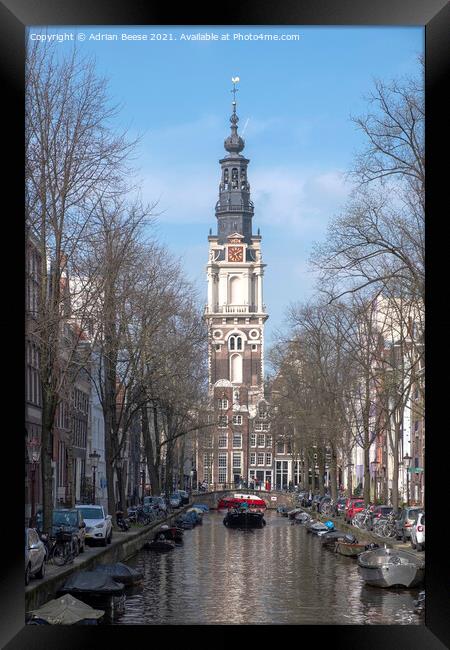 Ornate Church Clocktower at the end of a canal in Amsterdam Framed Print by Adrian Beese
