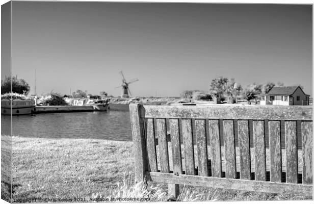 Wooden bench on the bank of the River Thurne Canvas Print by Chris Yaxley
