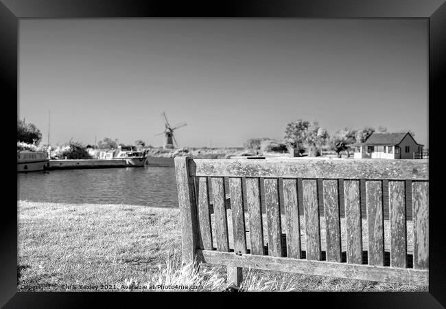 Wooden bench on the bank of the River Thurne Framed Print by Chris Yaxley