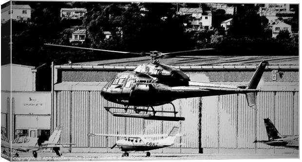 Helicopter hovering in Monochrome Canvas Print by Ann Biddlecombe