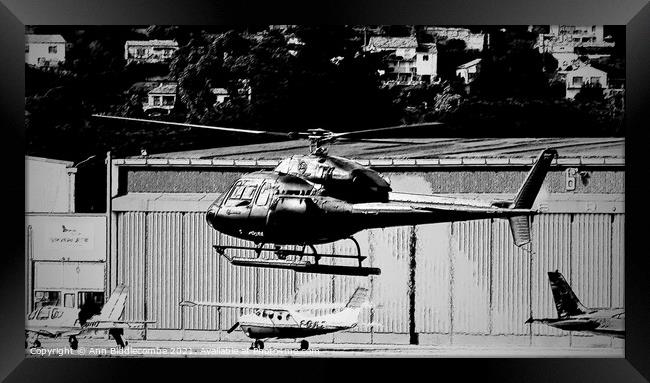 Helicopter hovering in Monochrome Framed Print by Ann Biddlecombe