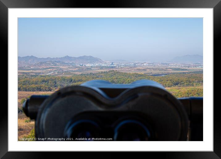 A view into North Korea across the DMZ from South Korea, from behind binoculars Framed Mounted Print by SnapT Photography