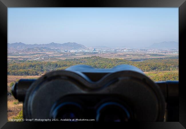A view into North Korea across the DMZ from South Korea, from behind binoculars Framed Print by SnapT Photography