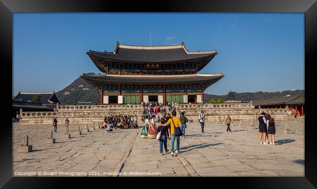 Tourists at the entrance to Gyeongbokgung Palace on a fall day in Seoul Framed Print by SnapT Photography