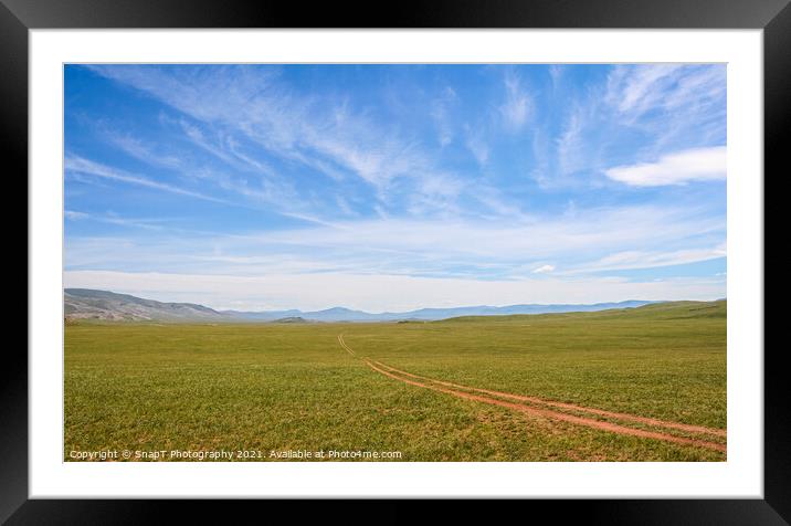 A track across a Mongolian grassland with mountains in the background Framed Mounted Print by SnapT Photography