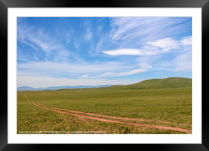 A track across a Mongolian grassland with mountains in the background Framed Mounted Print by SnapT Photography