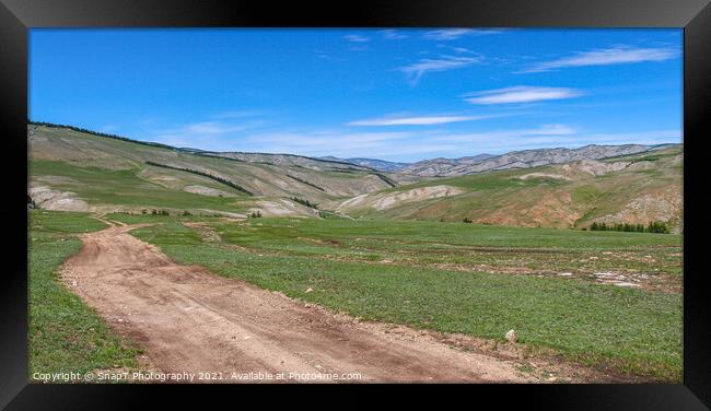 Dirt track leading up a Mongolian grassland valley on a summer day Framed Print by SnapT Photography