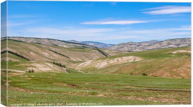 Rolling Mongolian hills and mountains, with a blue cloudy sky Canvas Print by SnapT Photography