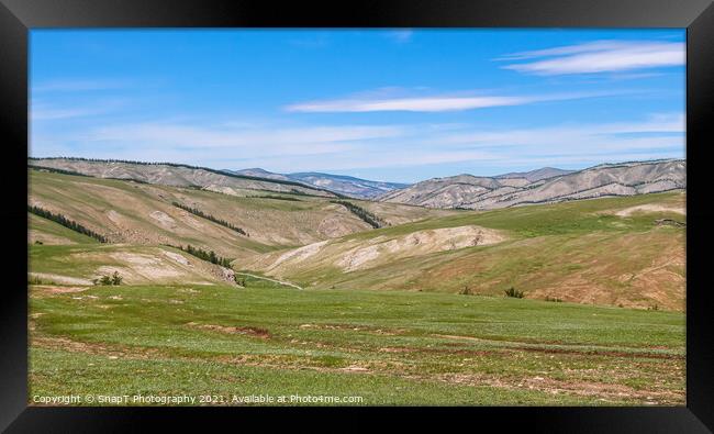 Rolling Mongolian hills and mountains, with a blue cloudy sky Framed Print by SnapT Photography