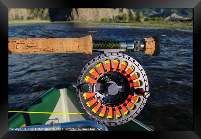 Close up of a fly fishing rod and reel in the late evening sun Framed Print by SnapT Photography