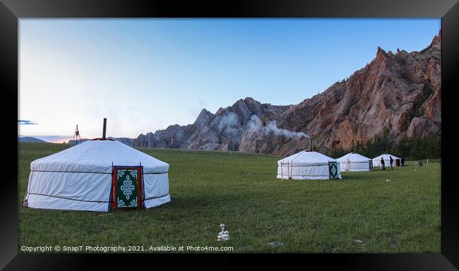 A row of Mongolian gers at a camp at sunset on a summers night, with chimney smoke Framed Print by SnapT Photography