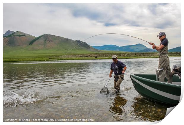 A fisherman with a Taimen Trout on the end of his line in Mongolia, Moron, Mongolia - July 14th 2014 Print by SnapT Photography