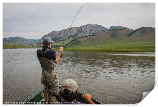 A fisherman with a Taimen Trout on the end of his line in Mongolia, Moron, Mongolia - July 14th 2014 Print by SnapT Photography