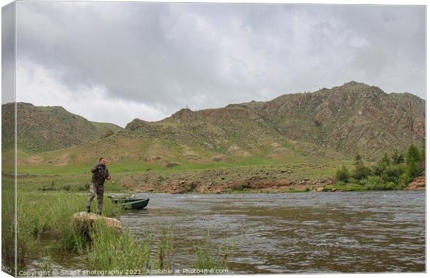 Fly fisherman casting a fly on a river in Mongolia during the summer, Moron, Mongolia Canvas Print by SnapT Photography