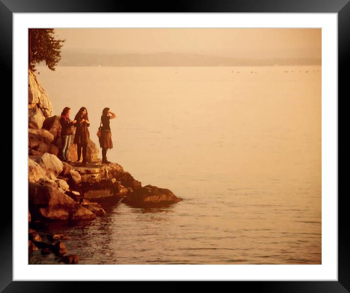 Three girls at sunset on the sea border  Framed Mounted Print by Luisa Vallon Fumi
