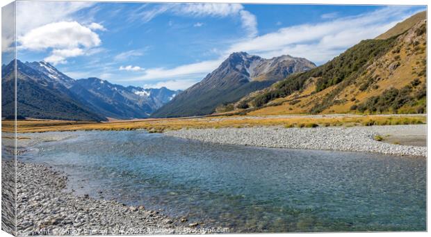 A shallow, fast flowing river, in the mountains of New Zealand on a sunny day Canvas Print by SnapT Photography