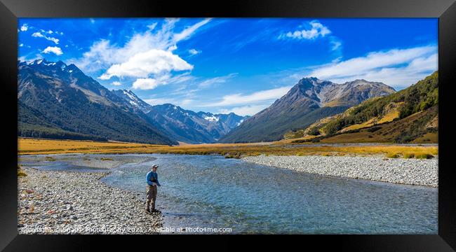 An Angler fly fishing for trout on the Ahuriri river, surrounded by mountains Framed Print by SnapT Photography