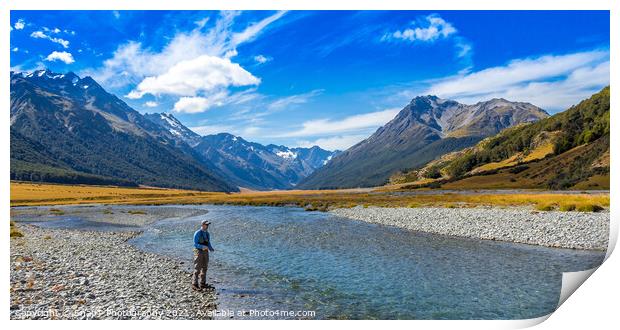 An Angler fly fishing for trout on the Ahuriri river, surrounded by mountains Print by SnapT Photography
