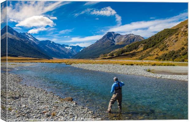 A fly fisherman casting on a beautiful mountain stream in New Zealand Canvas Print by SnapT Photography