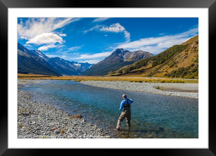 A fly fisherman casting on a beautiful mountain stream in New Zealand Framed Mounted Print by SnapT Photography