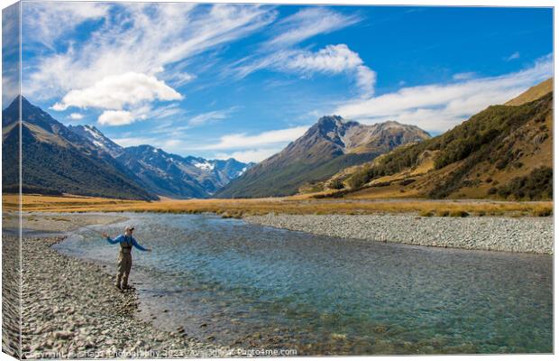 A fly fisherman casting for trout on the Ahuriri River in New Zealand Canvas Print by SnapT Photography