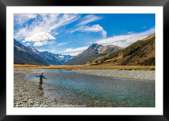 A fly fisherman casting for trout on the Ahuriri River in New Zealand Framed Mounted Print by SnapT Photography