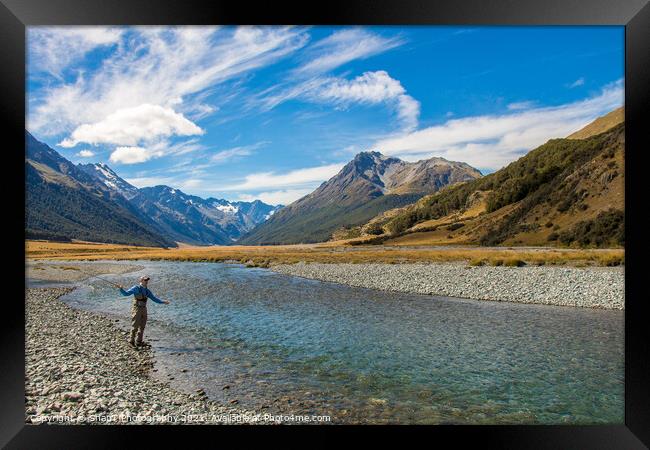 A fly fisherman casting for trout on the Ahuriri River in New Zealand Framed Print by SnapT Photography
