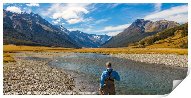 An fly fisherman looking for trout in the mountains of the Ahuriri River Print by SnapT Photography