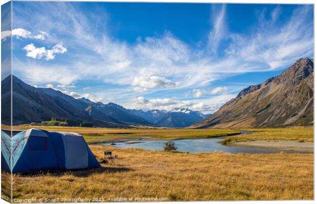 A tent pitched beside a river, surrounded by mountains, in New Zealand Canvas Print by SnapT Photography