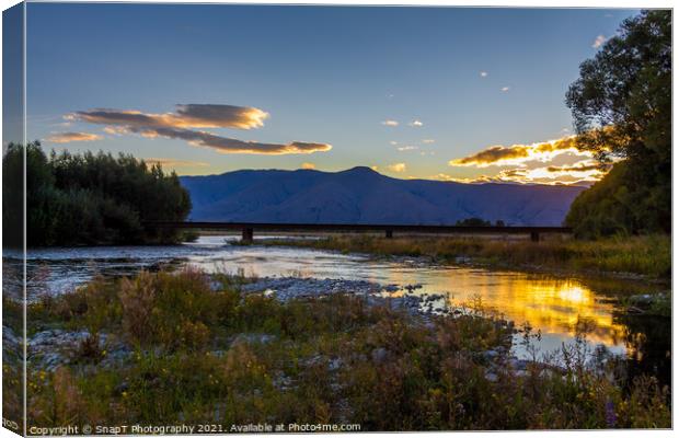 Sunset on the Tekapo River, with mountains in the background in summer Canvas Print by SnapT Photography