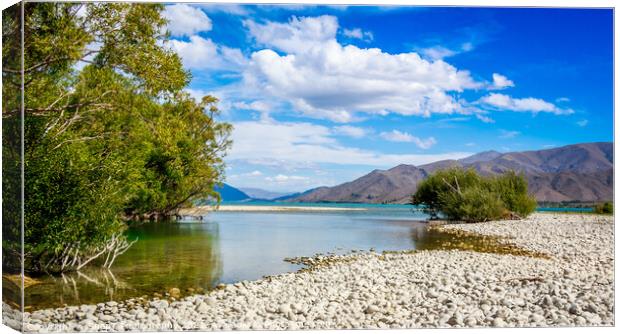 The slow flowing Pukaki river as it flows into Lake Benmore on a sunny day Canvas Print by SnapT Photography