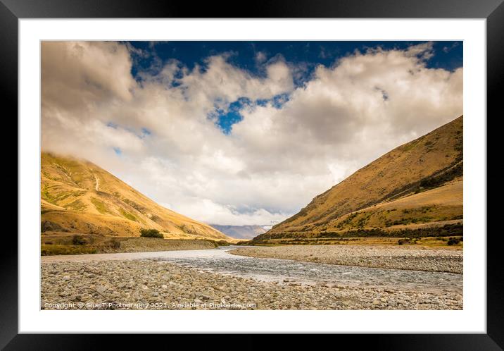 A New Zealand mountain stream in a V shaped valley with dramatic clouds Framed Mounted Print by SnapT Photography