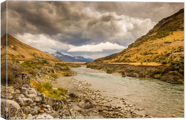 A mountain landscape and river on a cloudy day in New Zealand near Omarama Canvas Print by SnapT Photography