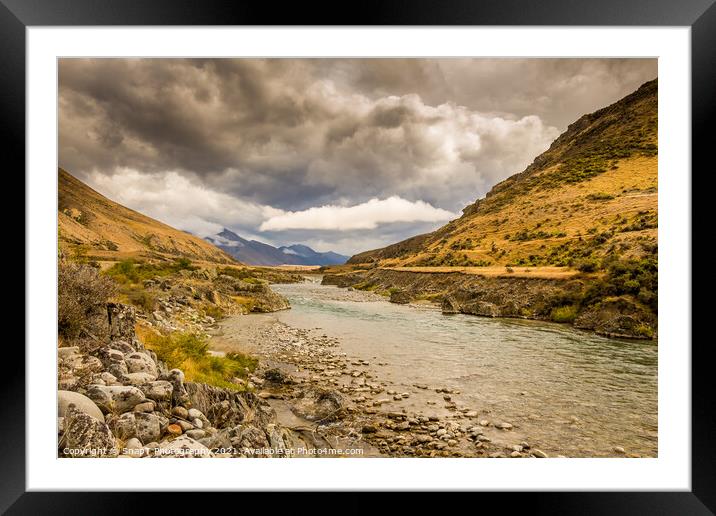A mountain landscape and river on a cloudy day in New Zealand near Omarama Framed Mounted Print by SnapT Photography