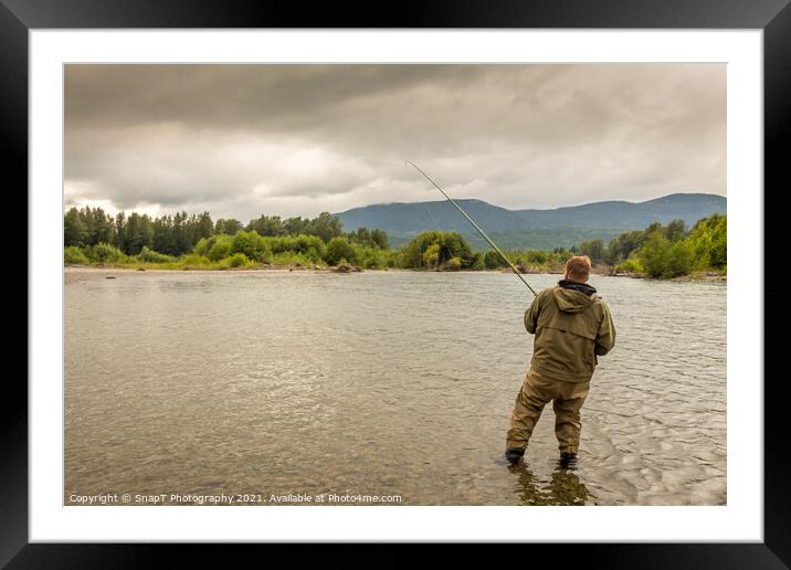 Fisherman battling a fish with a bent rod, while wading. Framed Mounted Print by SnapT Photography