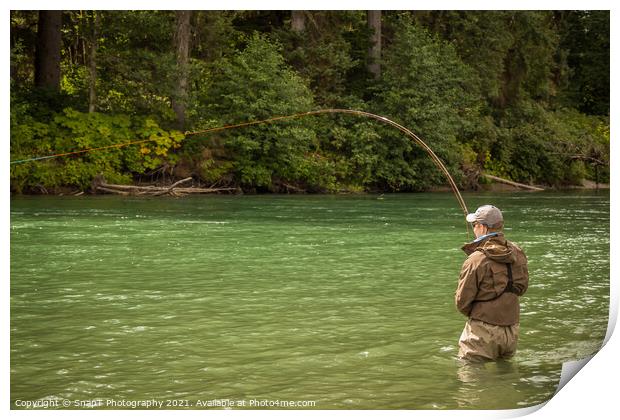 A man hooked into a fish while fly fishing on a deep green river. Print by SnapT Photography